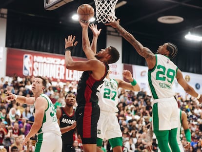 Miami Heat center Orlando Robinson, center front, makes a basket as Boston Celtics guard Jay Scrubb (29) tries to keep him from the net during an NBA Summer League basketball game Saturday, July 8, 2023, in Las Vegas.