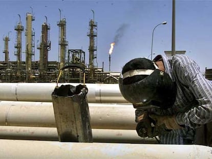 Un operario repara instalaciones petrolíferas en Irak.