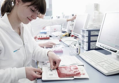 Una técnica de laboratorio etiqueta una bolsa de conservación sanguínea.