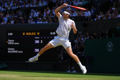 El tenista estadounidense Taylor Fritz devuelve la pelota al español Carlos Alcaraz.
