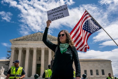 A protester listens to speakers during a Planned Parenthood rally