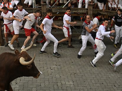 Los mozos, durante el octavo encierro de los Sanfermines, con toros de la ganadería de Miura, este jueves en Pamplona.