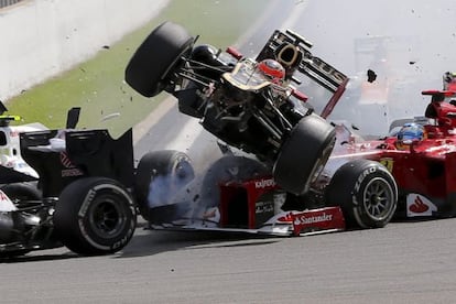 Romain Grosjean's Lotus (center) flies over Fernando Alonso's Ferrari at Spa on Sunday.