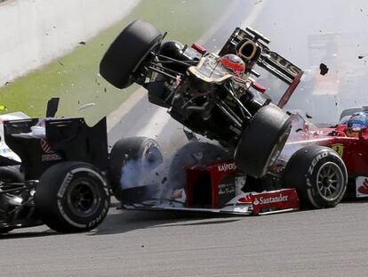 Romain Grosjean&#039;s Lotus (center) flies over Fernando Alonso&#039;s Ferrari at Spa on Sunday. 