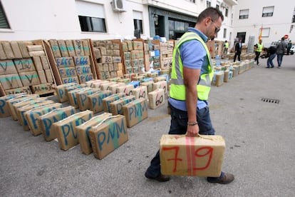 An officer from the Civil Guard moves a packet of hashish from the 32.3-ton haul of the drug that was intercepted in a truck at the port of Algeciras, C&aacute;diz province.