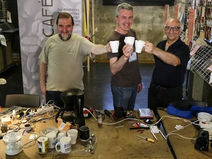 De izquierda a derecha, Javier Vázquez, encargado de la comunicación de Repair Café MediaLab-Prado (Madrid); José Ramón Martín, un reparador voluntario, y José Manuel Gutiérrez, otro reparador habitual de este proyecto, mientras comparten un café.