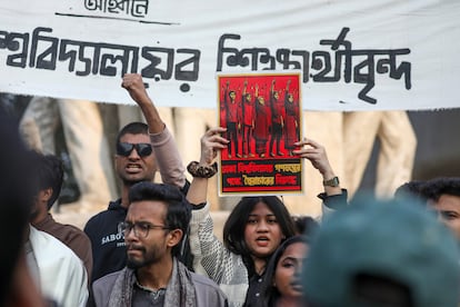 University students hold placards as they protest, demanding an election under a caretaker government, in front of the Raju Memorial Sculpture at the University of Dhaka, on January 6, 2024.