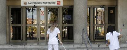 Dos limpiadoras barren el acceso a los juzgados de la plaza de Castilla. 