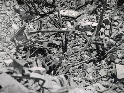 Nazi soldier studies wreckage from bomb attack on four Spanish villages.