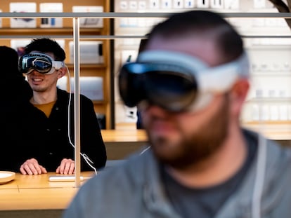 Customers try on the Apple Vision Pro at an Apple store in The Grove, Los Angeles, during the launch on February 2, 2024.
