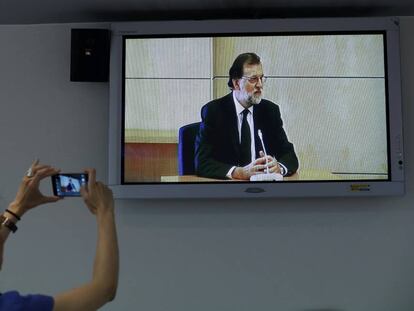 Una periodista hace una foto a Mariano Rajoy mientras declara por el 'caso Gürtel'.