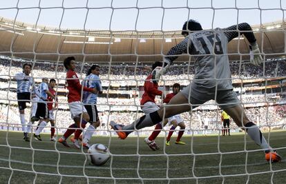 El guardameta Jung Sung-ryong no alcanza a zanjar un balón rebotado en la pierna de su compañero Park Chu-young.