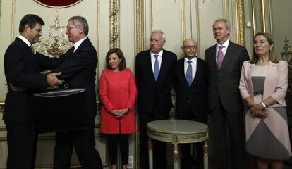 Rafael Catalá recibe el saludo de Alberto Ruiz-Gallardón el 29 de septiembre de 2014 tras su toma de posesión como ministro de Justicia, en presencia de Soraya Sáenz de Santamaría en presencia de del fiscal general, Torres Dulce, y varios ministros. Gallardón abandonó la cartera de Justicia al ver frustrada su reforma de la ley del aborto.