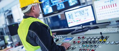 Senior Technician Working at Computer Station