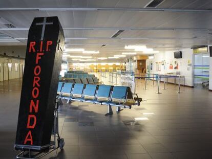 Ataud en la terminal vacía de pasajeros del aeropuerto de Foronda con el que el comité de empresa quiere simbolizar su posible cierre.