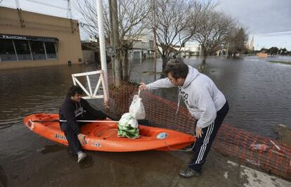 Un hombre se movilizaba en un kayak por una calle inundada en la localidad de Luj&aacute;n, a 60 kil&oacute;metros de Buenos Aires, este mi&eacute;rcoles.