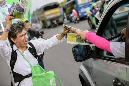 Claudia López reparte periódicos en las calles de Bogotá.