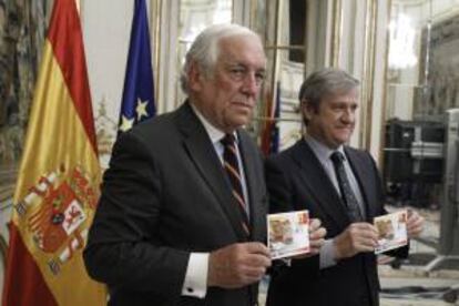 El Alto Comisionado del Gobierno para la Marca España, Carlos Espinosa de los Monteros (i), y el presidente de Correos, Javier Cuesta Nuin (d), durante la presentación del primer sello de la nueva serie filatélica "Marca España".