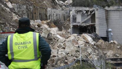 Un agente de la Guardia Civil observa el corrimiento de tierras en Cortes de Pall&aacute;s.