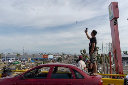 A man looks for a signal on a bridge on the Boulevard of Nations, in Acapulco.