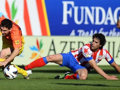 Messi trata de zafarse de Tiago.