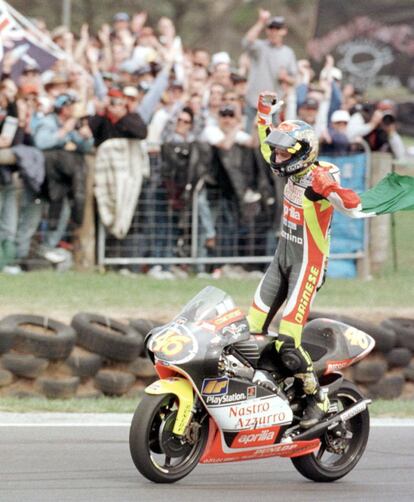 El italiano Valentino Rossi hace un gesto de victoria con una bandera italiana tras ganar el Gran Premio de Motociclismo australiano de 250cc en Phillip Island.