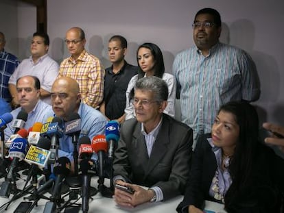 MUD secretary general Jesús Torrealba (center) during a news conference.