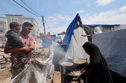 A family prepares for the end of Ramadan in a tent in Rafah last Monday.