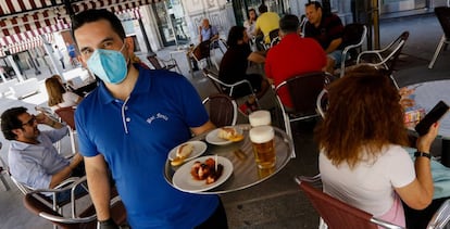 Clients at sidewalk terraces in Plaza de las Flores, in the city of Murcia.