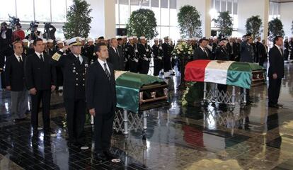 President Enrique Pe&ntilde;a Nieto (left) presides over funeral ceremonies Monday for Deputy Admiral Carlos Salazar and his bodyguard Francisco Ricardo Hern&aacute;ndez.