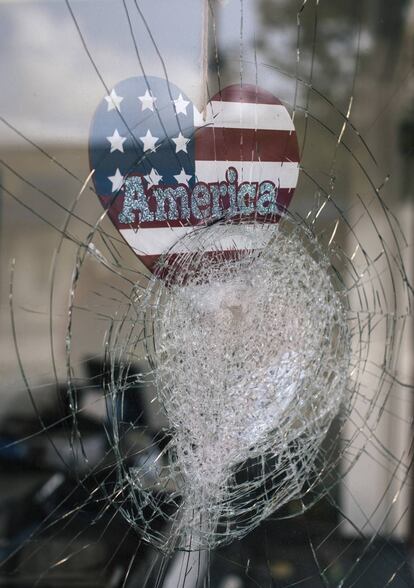 <b>Las cosas, como son. </b>Una pegatina con la palabra “América” en la ventana rota de un negocio en Kenosha (Wisconsin) el 25 de agosto tras los disturbios contra el racismo se convierte en símbolo del daño que la mentira ha hecho en un país, Estado Unidos, donde incluso su presidente ha difundido bulos.