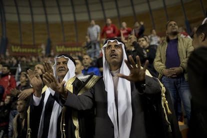 Bnei Sakhnin soccer supporters watch a game against Beitar Jerusalem FC at the Teddy Stadium in Jerusalem, Sunday, Feb. 10, 2013. Hundreds of police deployed around Beitar Jerusalem's stadium, two days after a suspicious fire believed to be set by angry fans destroyed the team's main offices. Tensions remained high Sunday as the team faced off with Bnei Sakhnin, an Arab team whose fans have clashed before with Beitar's. (AP Photo/Bernat Armangue)