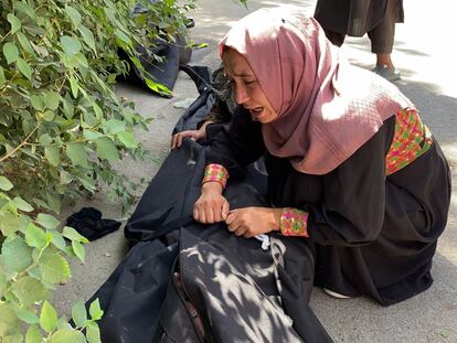 Una mujer llora en el exterior de un hospital de Kabul junto al cadáver de una víctima del atentado.