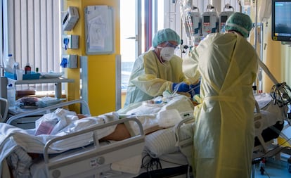 Nurses help a patient in an intensive care unit in Germany.