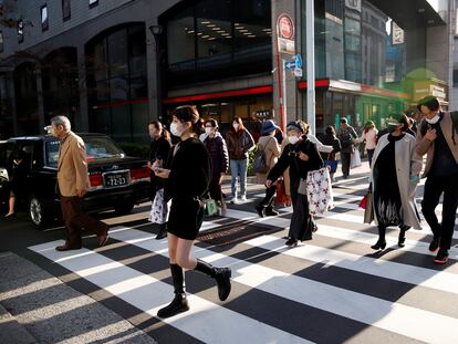 Viandantes cruzan una calle en la zona comercial de Ginza, en Japón.