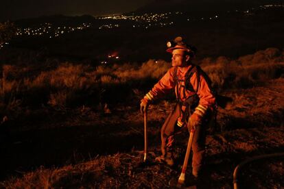 Un bombero observa el fuego, durante un descanso de los trabajos de extincin del incendio en las monta?as de Potrero Road, California.