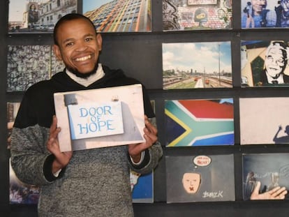 Sphiwe, quien abandonó la vida en la calle por hacer fotografías, muestra una de sus creaciones con la cámara. 