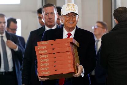 Donald Trump arrives to deliver pizza to fire fighters at Waukee Fire Department in Waukee, Iowa, Sunday, Jan. 14, 2024. 