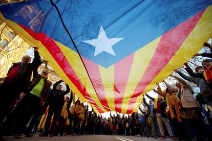 Un grupo de manifestantes portan una gran 'estelada', este sábado en el centro de Barcelona.