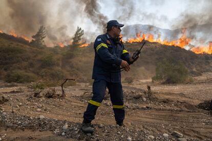 Un bombero trabaja cerca de las llamas en la localidad de Vati, este martes.  