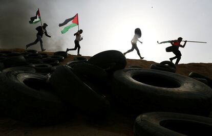 Manifestantes palestinos corren durante los enfrentamientos con las tropas israelíes en la frontera entre Israel y Gaza, en el sur de Gaza.