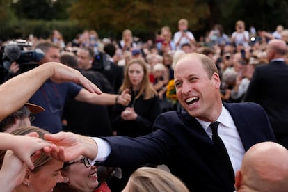 Prince William greets people gathered on Saturday around Windsor Castle.