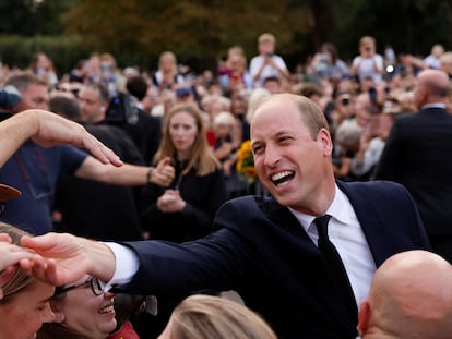 Prince William greets people gathered on Saturday around Windsor Castle.