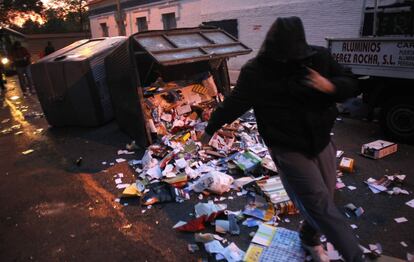 Un hombre sale corriendo tras tirar un contenedor de basura al suelo en el centro de Madrid. La Policía Nacional ha detenido esta madrugada a cinco personas por quemar varios contenedores de basura en el madrileño distrito de Carabanchel, actos violentos relacionados con la huelga de limpieza viaria que ha comenzado hoy.