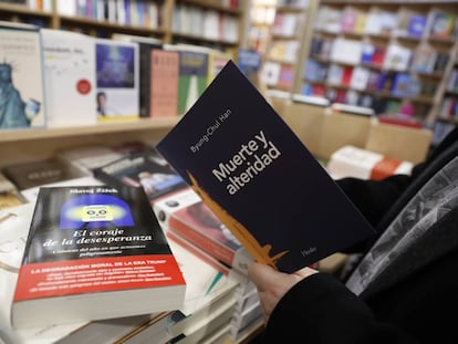 Un hombre toma un libro de filosofía en la la librería Antonio Machado de Madrid.