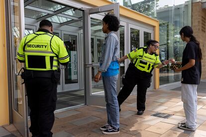 Security guards check identification for proof of age outside the Mall in Columbia, on May 12, 2023, in Columbia, Maryland.