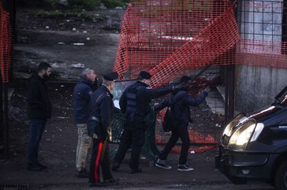 Un carabinero expulsa a uno de los migrantes alojados en la fbrica de penicilina.