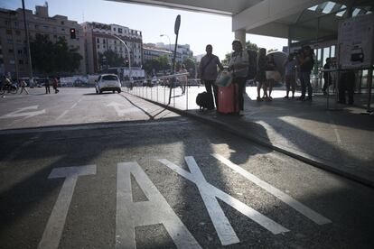 Viajeros afectados por la huelga de taxis en la estación de Atocha de Madrid.