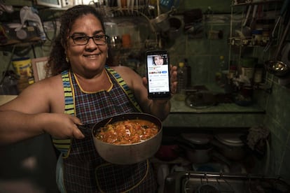 Yuliet Colón posa com a comida que preparou e seu telefone com sua página de cozinha de Facebook em sua casa em Havana, Cuba, o 2 de abril.
