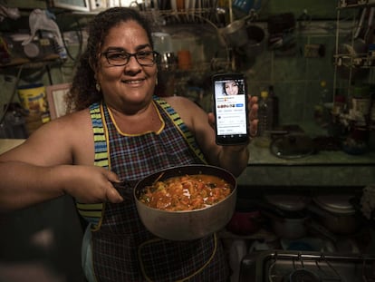 Yuliet Colón posa com a comida que preparou e seu telefone com sua página de cozinha de Facebook em sua casa em Havana, Cuba, o 2 de abril.